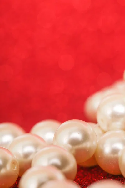 Pile of pearls on red. Pile of pearls on red Christmas background