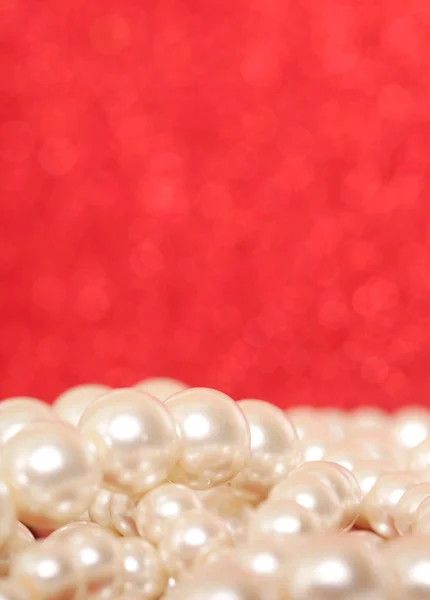 Pile of pearls on red. Pile of pearls on red Christmas background