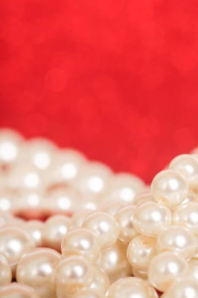 Pile of pearls on red. Pile of pearls on red Christmas background