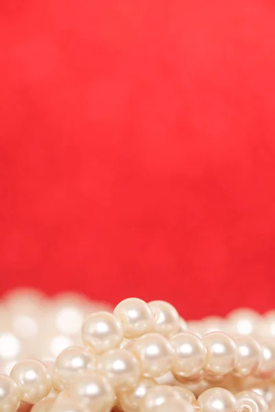 Pile of pearls on red. Pile of pearls on red Christmas background