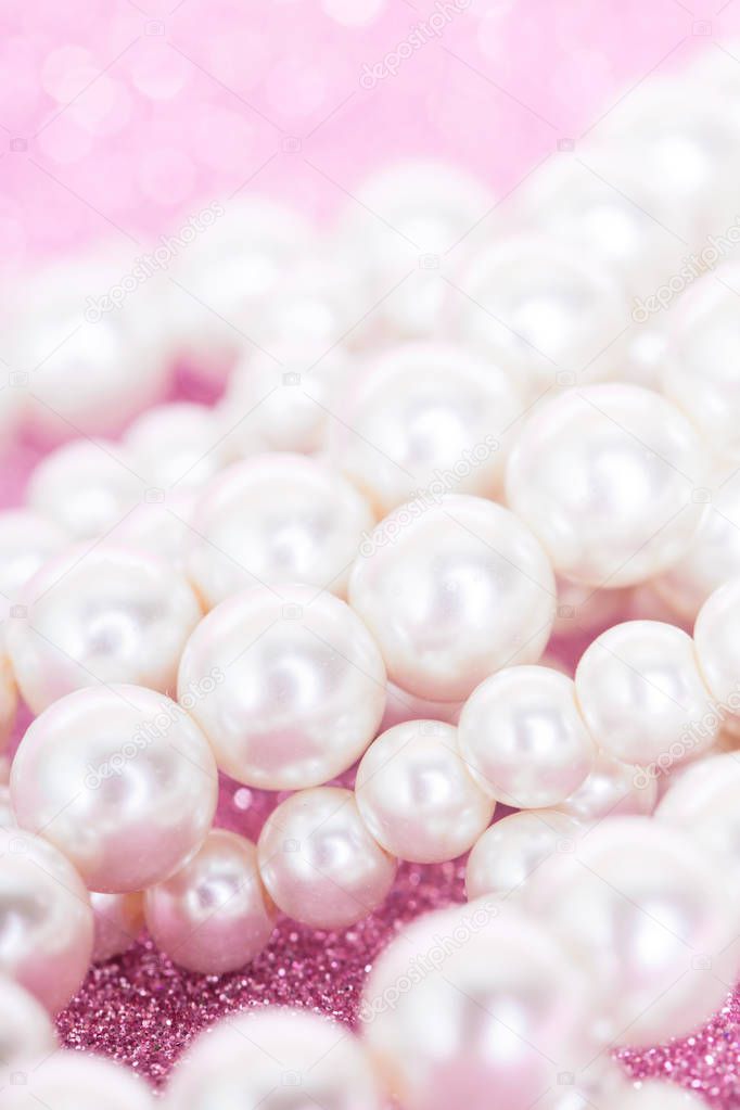 Pile of pearls on pink festive background