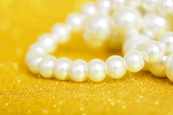 Pile of pearls on golden christmas background