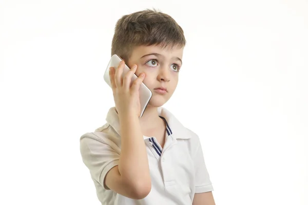 Studio shot of little boy with smart phone, kids cell phones addiction concept