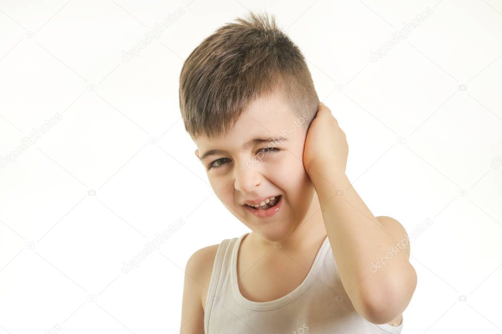 Studio shot of young boy with ear pain. Can not hear you concept.