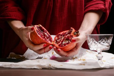 Pomegranate in hands - deseeding clipart