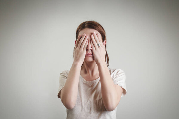 Woman hiding face with her hands