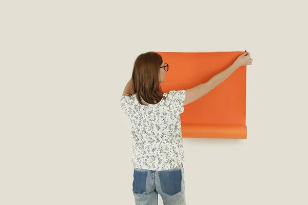 橙色纸卷的年轻设计师 — 图库照片