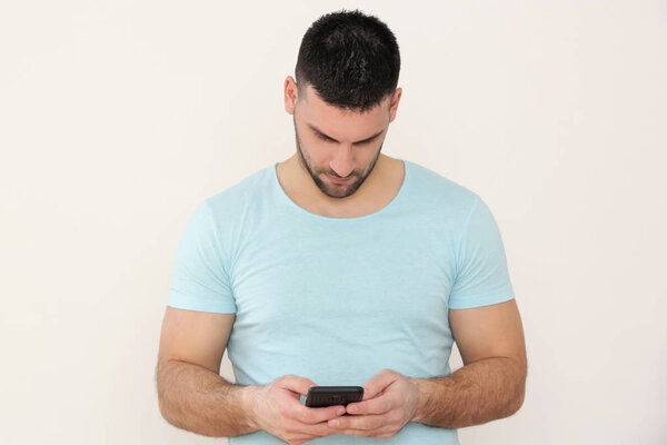 Portrait of a young man looking at his smartphone