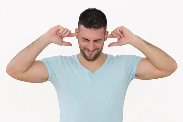Portrait of a young man plugging ears with fingers and winking, — Stock Photo, Image