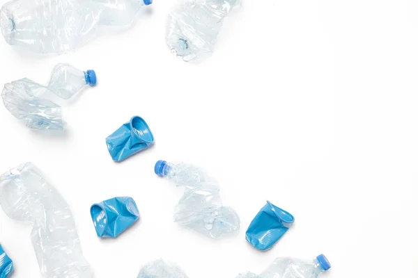 Crumpled empty single-use plastic cups and bottles, studio shot.