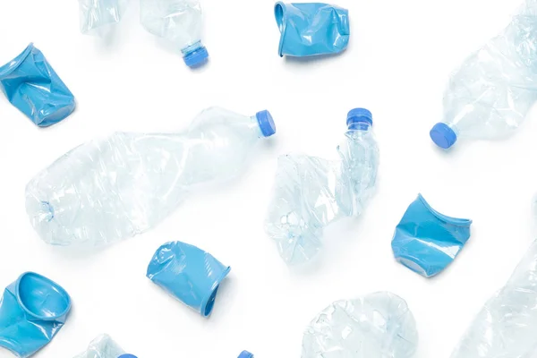 Crumpled empty single-use plastic cups and bottles, studio shot.