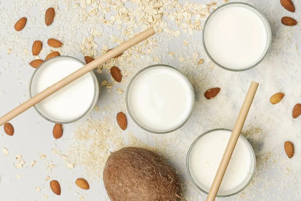 Assortment of organic vegan non-dairy plant-based milk in glasses, top view