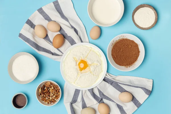 Creating a recipe, Top view of the basic baking ingredients on the blue table, cooking concept