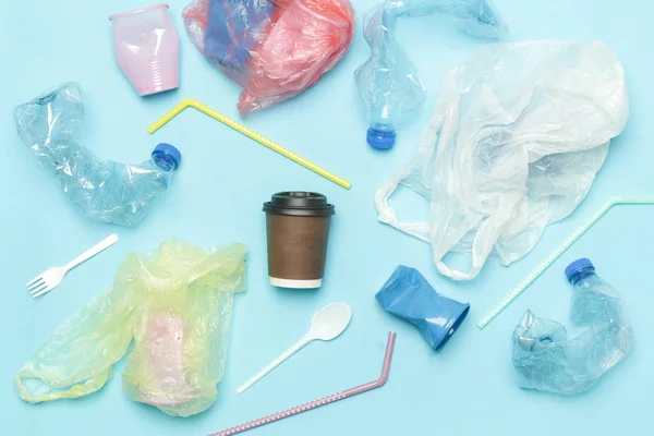 Single-use plastic waste, studio shot. Plastic pollution concept. Single-use plastic is a human addiction that is destroying our planet and impacts our waters, sea life and humans.