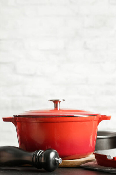 Cookware set: Red enameled cast iron pot, saucepan and bowls