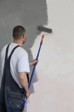 Beyaz bir duvar üzerinde gri boya ile adam boyama