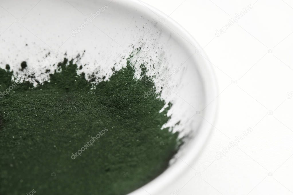 Greens powder in a bowl. Greens powders are dietary supplements designed to help you reach your daily recommended vegetable intake.
