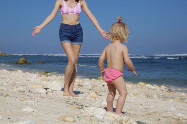 Anne, Aile yaz tatil konsepti ile plaj günü zevk mutlu oynak Toddler kız