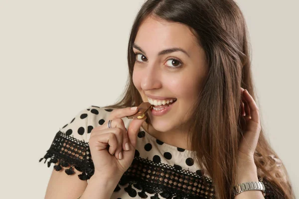 Young Attractive Woman Eating Piece Chocolate Studio Shot — Stock Photo, Image