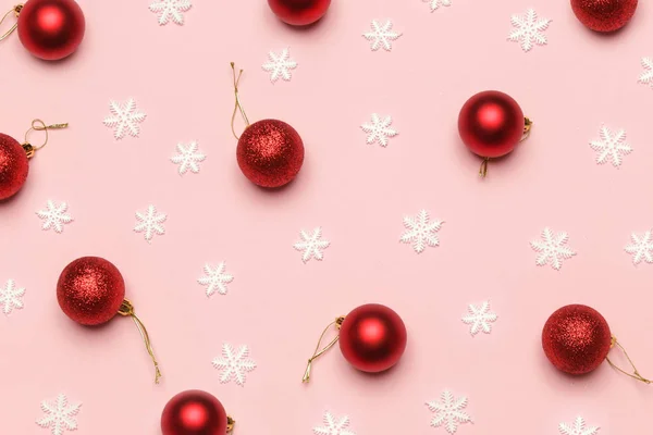 淡いピンクの背景に赤いクリスマスの装飾 — ストック写真