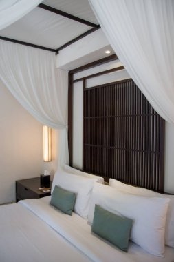 Simple contemporary bedroom with king size bed and mosquito net