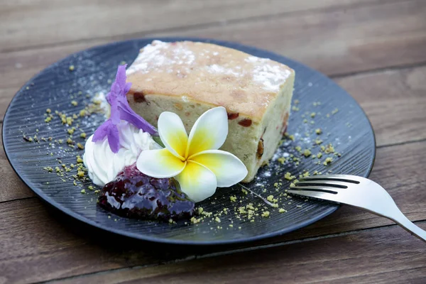 Raisin bread decorated with edible flowers served on the wooden table
