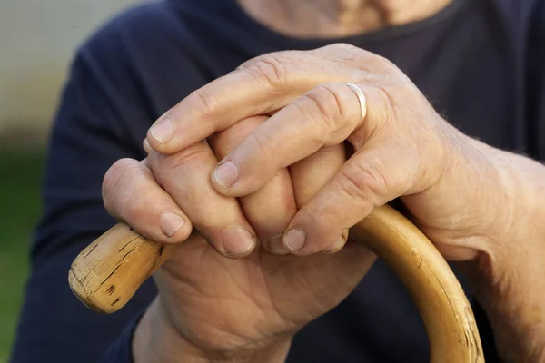 Elderly Womans Hands Holding Wooden Walking Stick — Stock Photo, Image