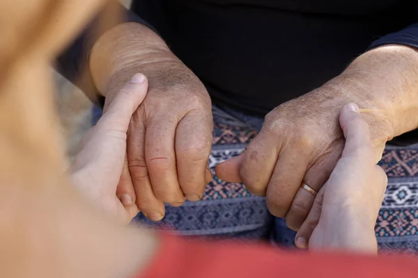 Holding hands. A picture of young and old hands. Concept of hope, care, love and support.