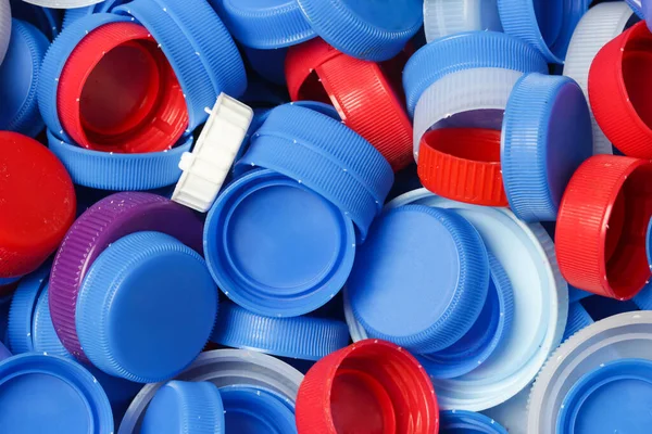 Heap of plastic bottle caps ready for recycling