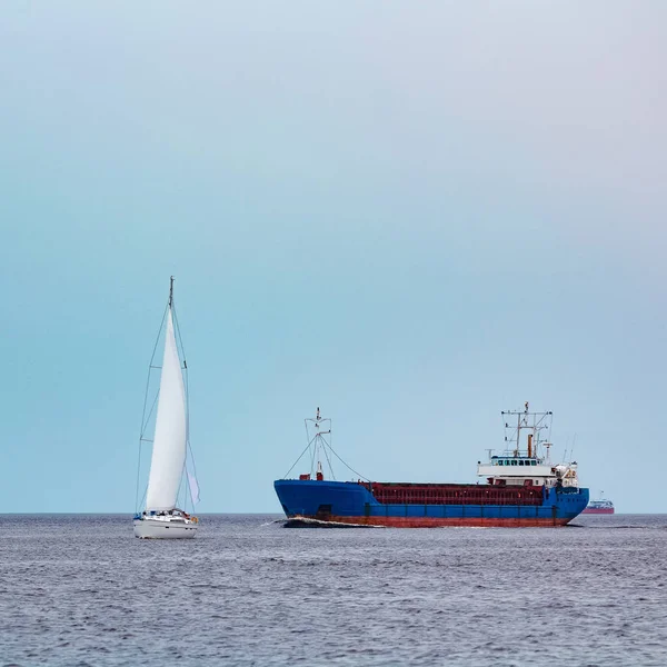 Merchandise import. Large blue cargo ship moving to Riga port