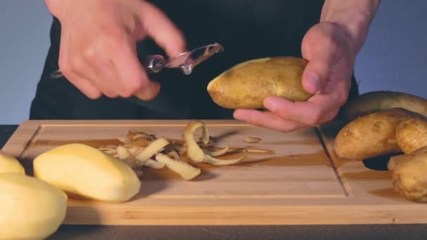 Man is Peeling Potato in a Kitchen — Stok Video