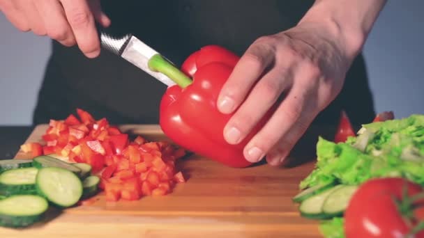 Chef rebanando pimentón rojo en la tabla de cortar — Vídeos de Stock