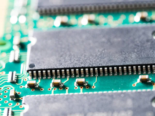 close-up of circuit board with integrated circuits, resistors and capacitors.