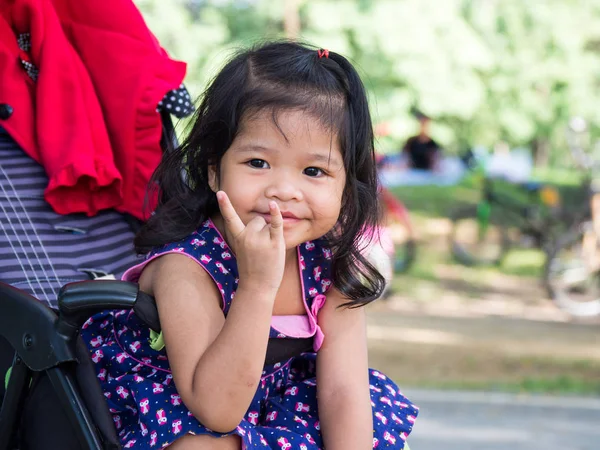 Little Asian Girl Sitting Stroller Public Park She Have Smile — Stock Photo, Image
