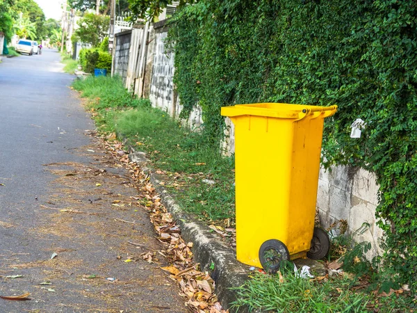 Yellow bins are placed on the side of the road in the village. Trash is for people in the village for left the garbage waiting to be Sorting for recycling.