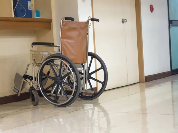 wheelchair parking in the front of blue public telephone in hospital. Wheelchair accessible for elderly or sick people.