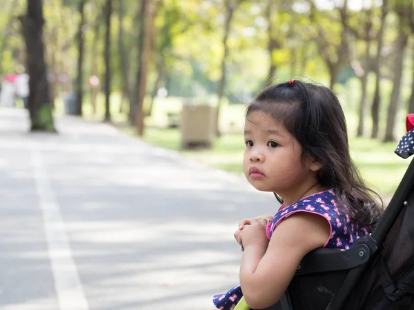 Little Asian Girl Sitting Stroller Public Park Eyes Girl Look — Stock Photo, Image