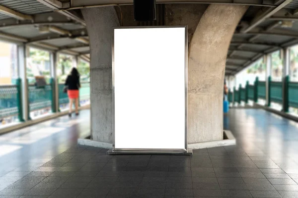 Blank mock up of vertical poster billboard on perspective horizontal outstanding on sky train platform
