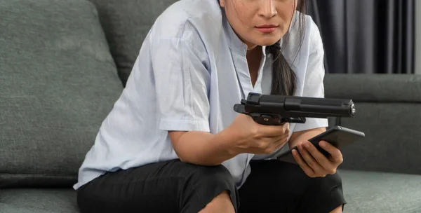 中年の女性が生活のストレスのためにリビングルームで銃を保持し 解決策とアドバイザーを見つけることができませんでした 家族における社会問題 ストレス 関係の概念 — ストック写真