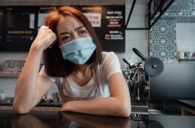 Asian woman coffee shop business owner Stressed and disappointed from The effects of the coronavirus pandemic resulting in business losses clipart