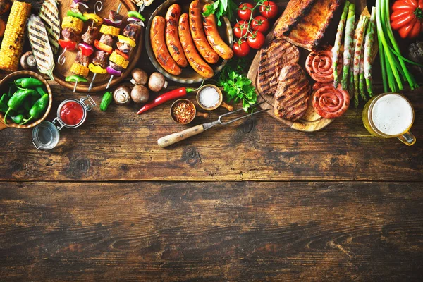 Grilled meat and vegetables on rustic wooden table. Barbecue menu