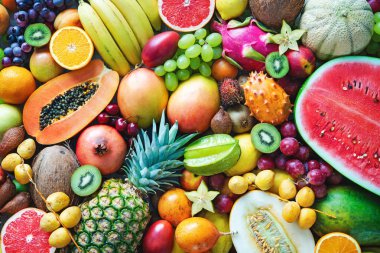 Food background. Assortment of colorful ripe tropical fruits. Top view clipart