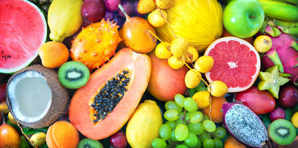 Food background. Assortment of colorful ripe tropical fruits. Top view