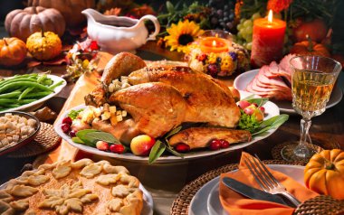 Thanksgiving dinner. Roasted turkey garnished with cranberries on a rustic style table decoraded with pumpkins, vegetables, pie, flowers and candles clipart
