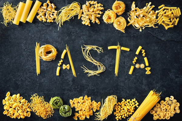 Various kinds of pasta over stone background. — Stock Photo, Image