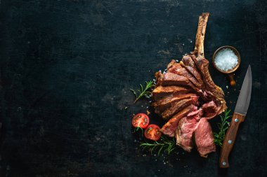 Grilled dry aged tomahawk steak sliced as close-up  clipart