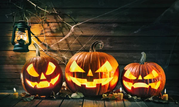 Halloween pumpkin head jack lantern with burning candles — Stock Photo, Image