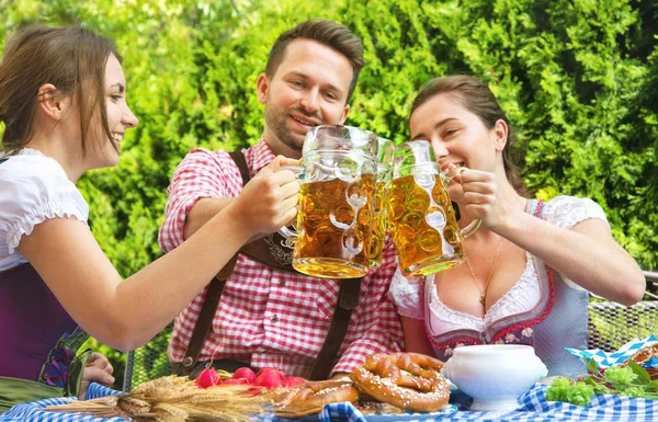 Young people in Tracht, Dindl and Lederhosen having fun in Beer — Stock Photo, Image