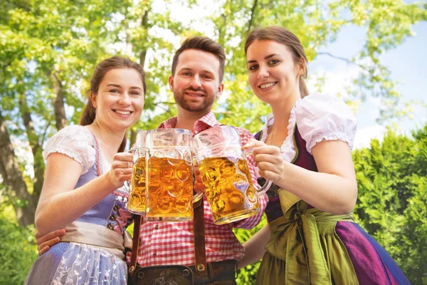 Young people in Tracht, Dirndl and Lederhosen having fun — Stock Photo, Image