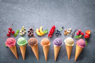 Various varieties of ice cream in cones clipart